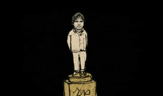 a man standing on a golden pedestal