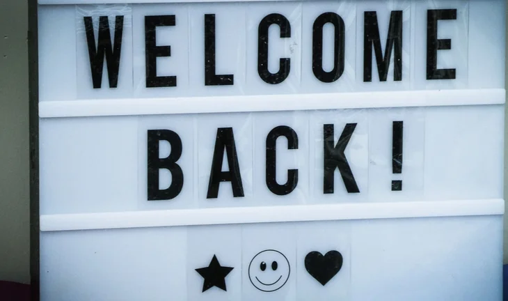 a sign that says welcome back 
