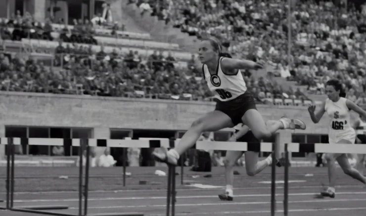 woman jumping a hurdle 