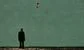 a man staring at a flying dollar bill